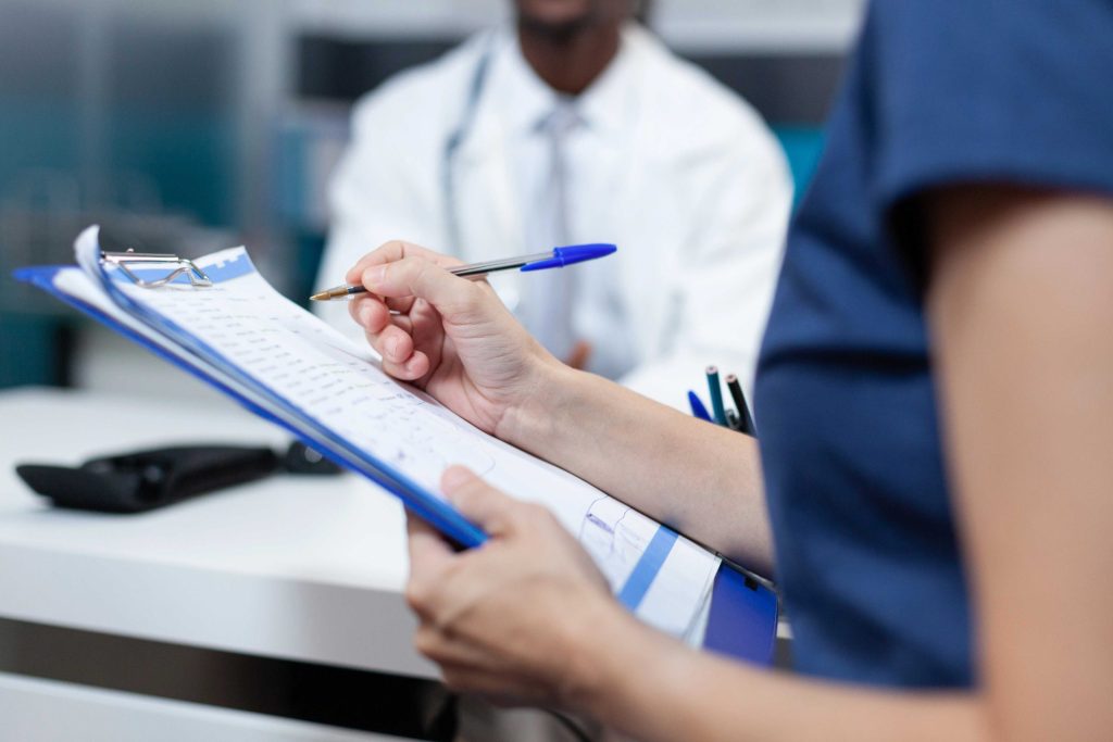 compressed closeup patient mother writing medical information document scaled